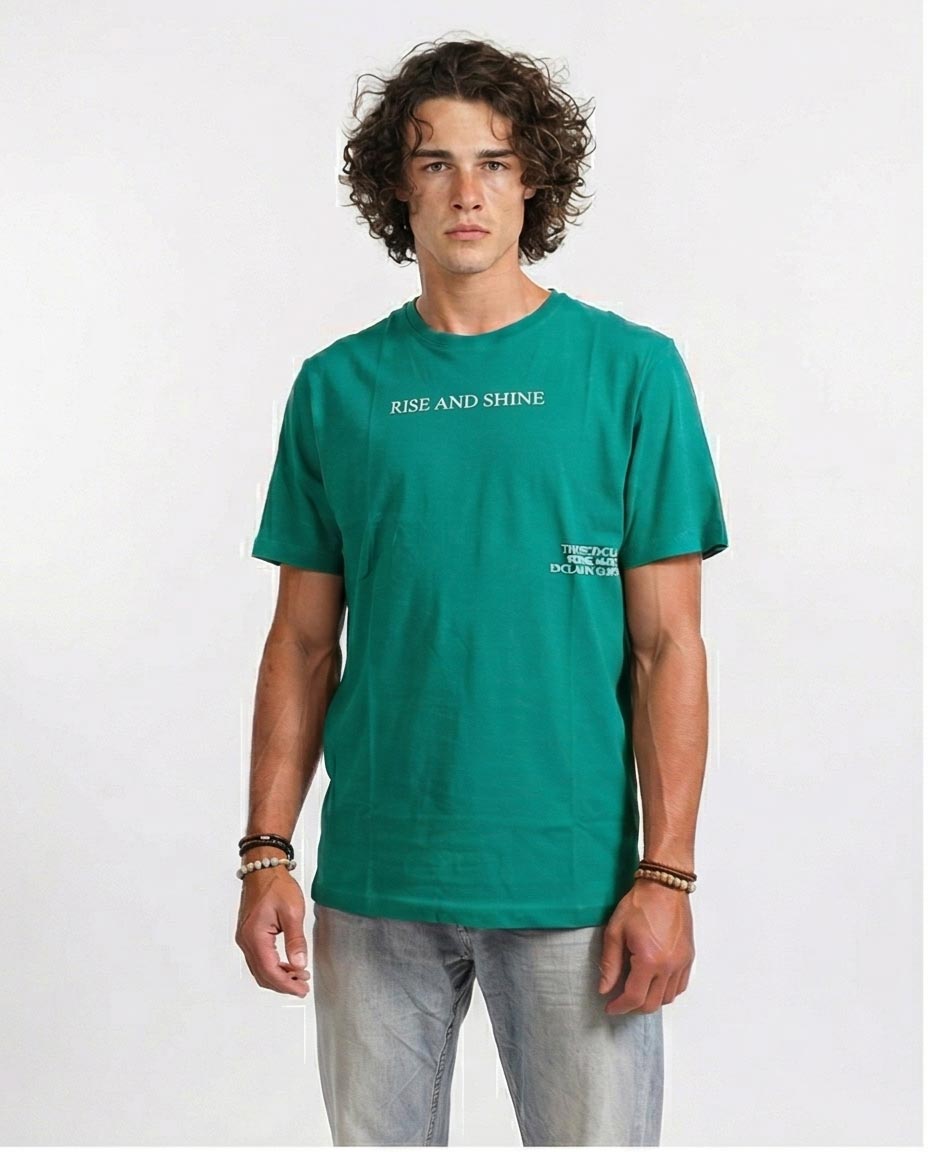 Man wearing a green t-shirt with 'RISE AND SHINE' text on a white background