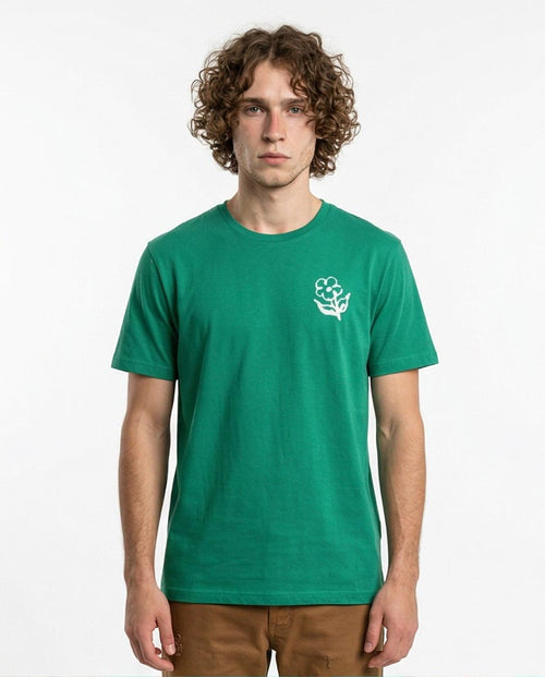 Man wearing a green t-shirt with a white logo on a white background