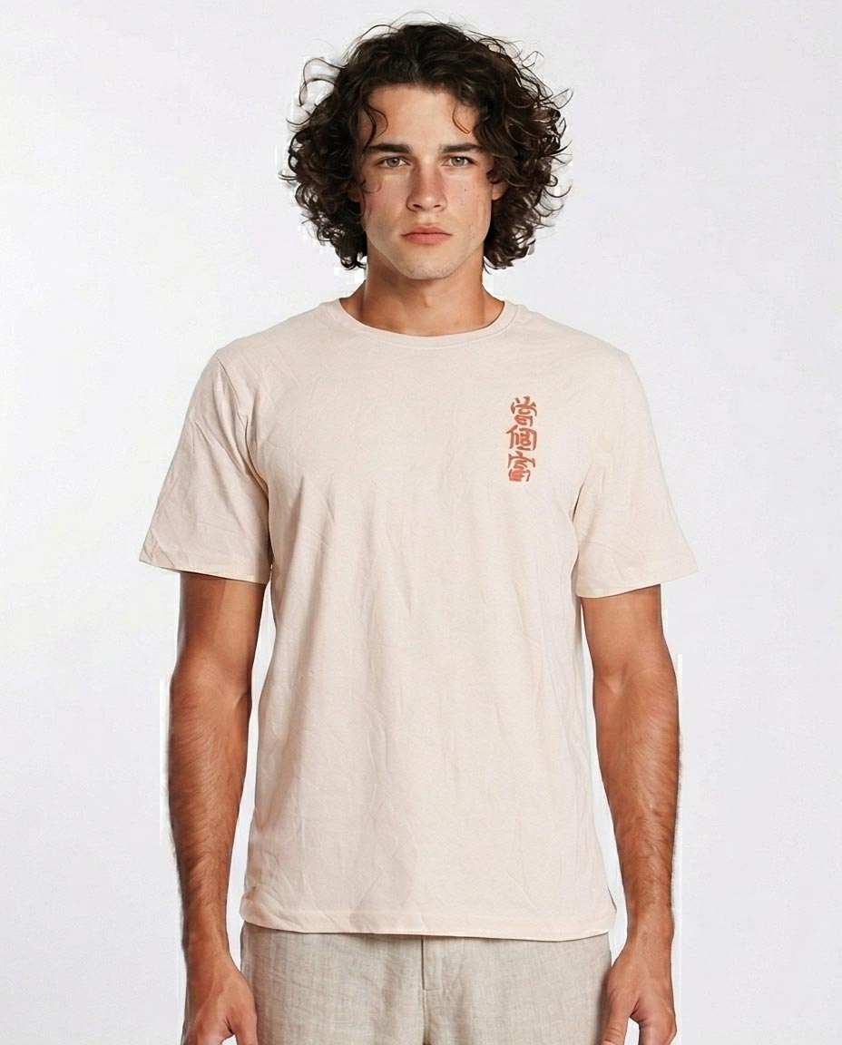 Man wearing a beige t-shirt with red text on a white background