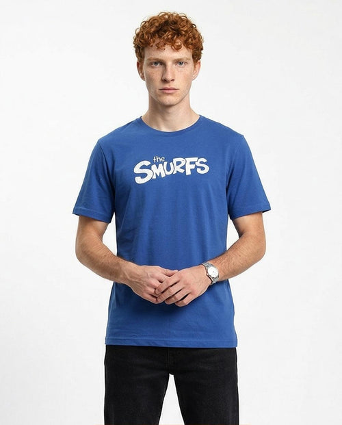 Person wearing a blue 'The Smurfs' t-shirt on a white background