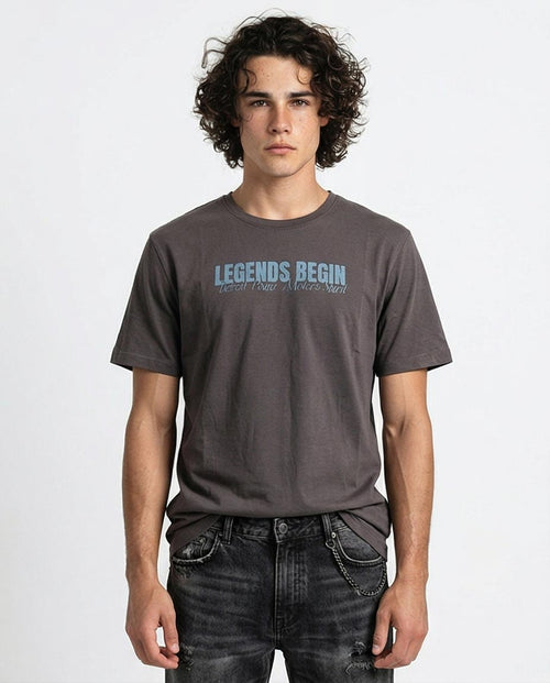 Man wearing a gray t-shirt with 'Legends Begin' text on a white background