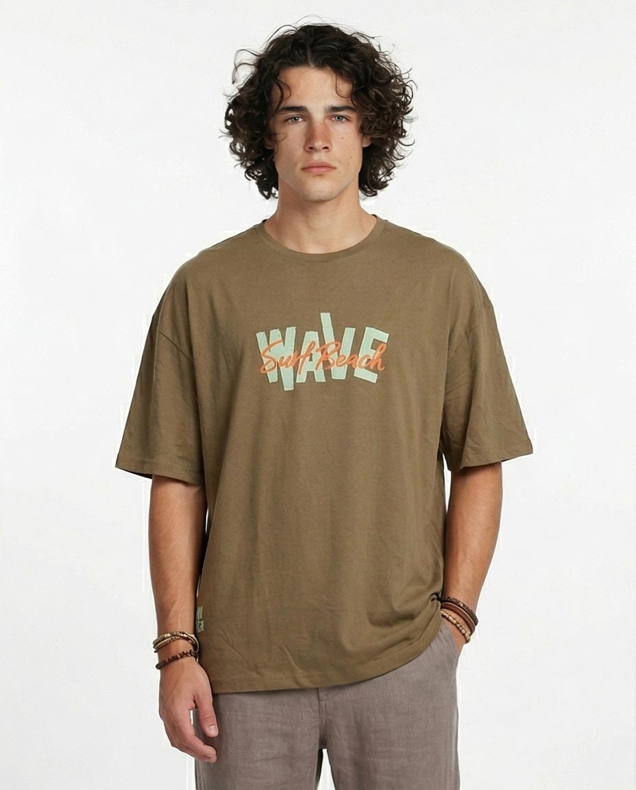 Man wearing a brown t-shirt with 'Wale' printed on it against a white background