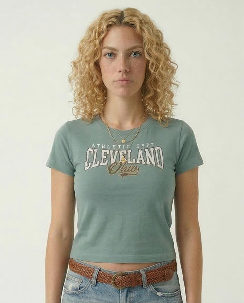 Woman wearing a green t-shirt with 'Athletic Dept Cleveland Ohio' text on a plain background