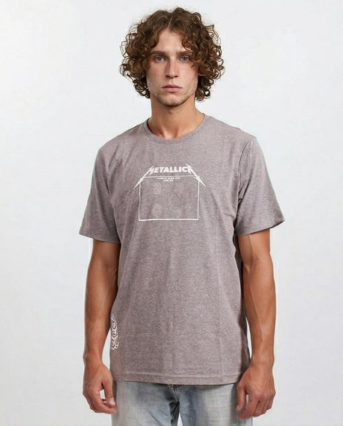 Man wearing a gray t-shirt with a white graphic design on a plain background