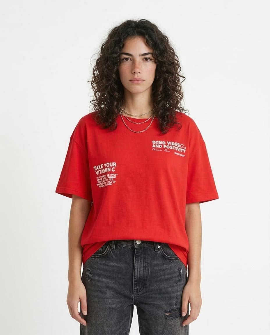 Person wearing a red t-shirt with text on a white background