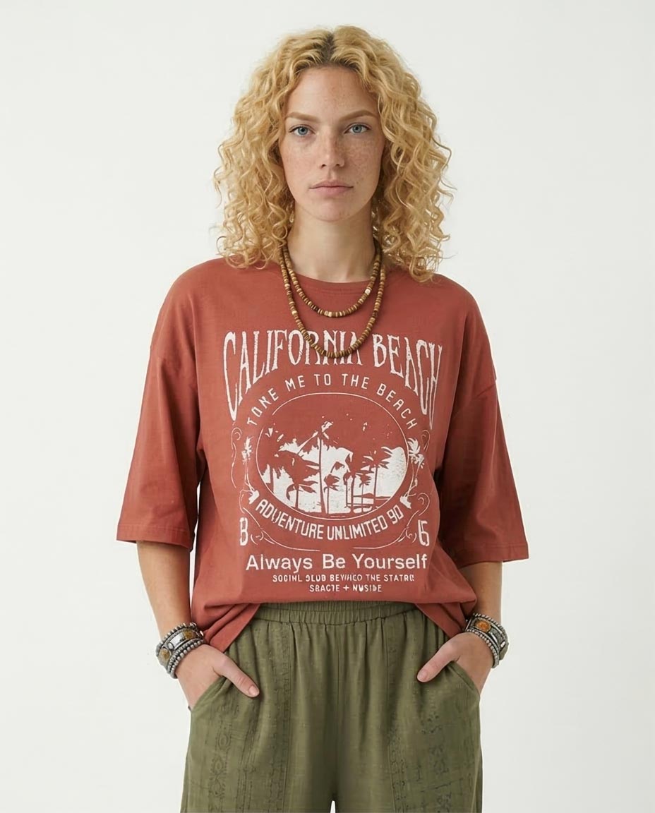 Person wearing a red 'California Beach' t-shirt with text and graphics on a white background