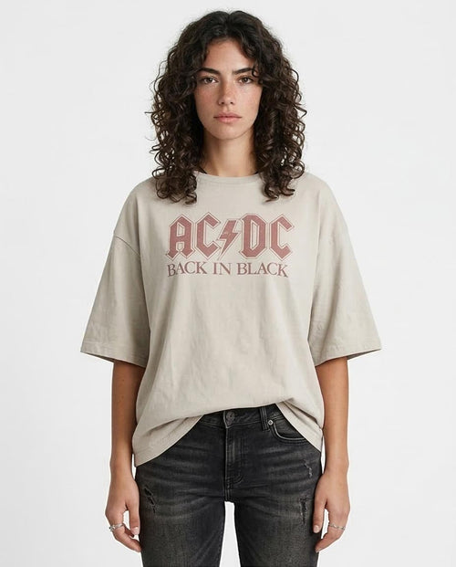 Person wearing a beige t-shirt with AC/DC logo and text on a white background