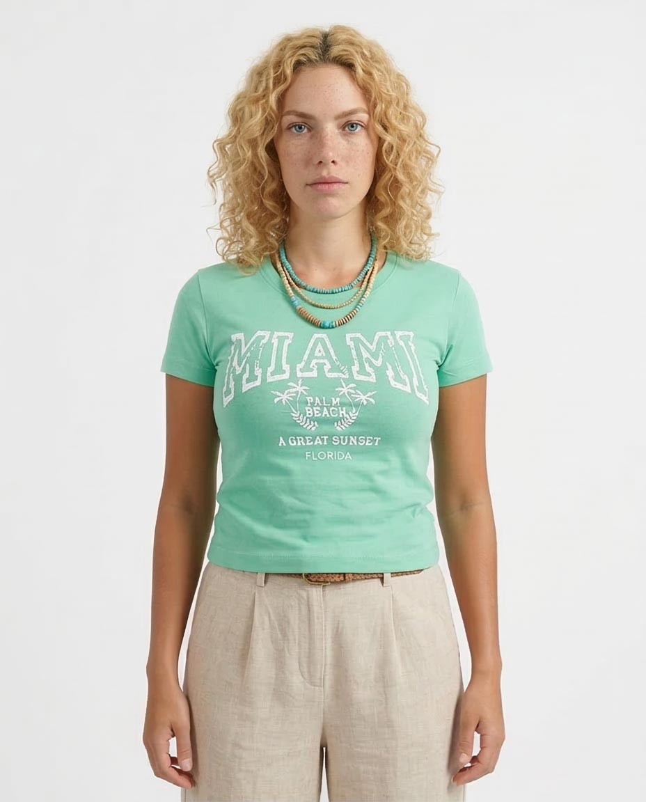 Woman wearing a green 'MIAMI' t-shirt with text on a white background