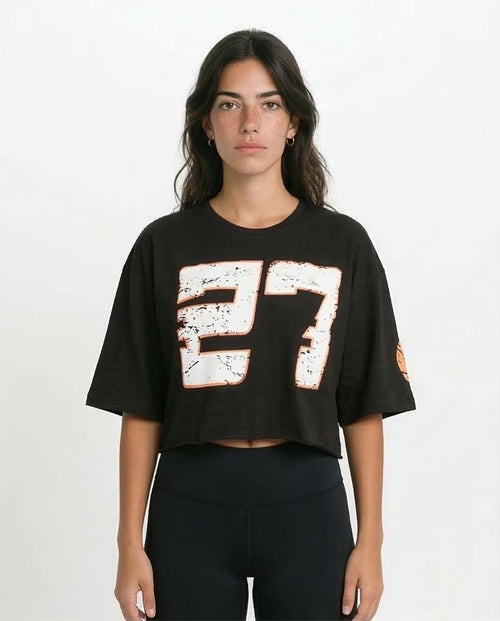 Person wearing a black t-shirt with '27' design on a white background