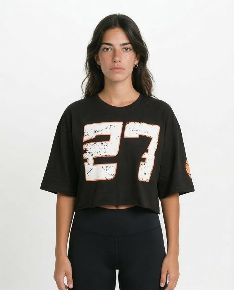 Person wearing a black t-shirt with '27' design on a white background