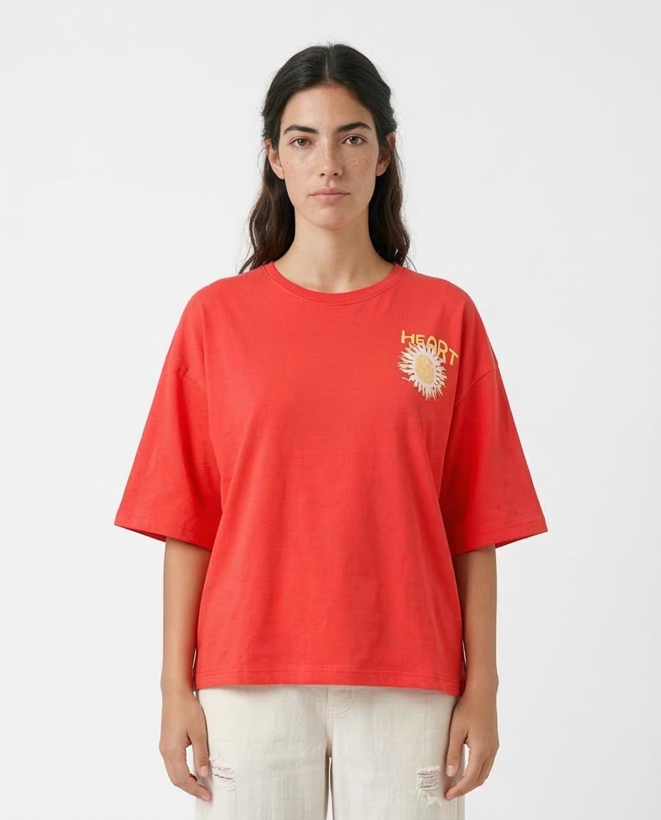Person wearing a red t-shirt with a logo on a white background