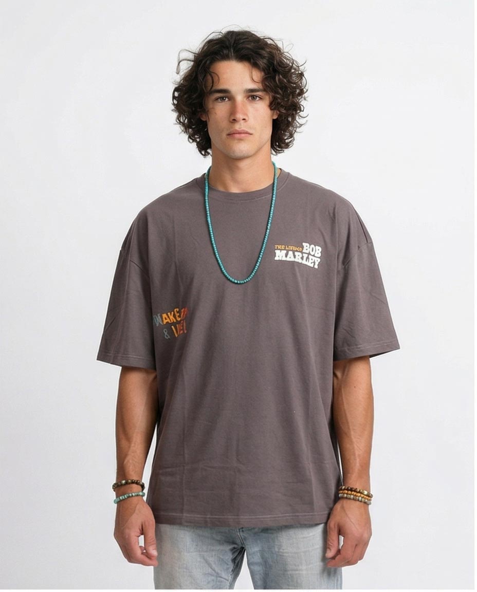 Man wearing a gray t-shirt with branding on a white background