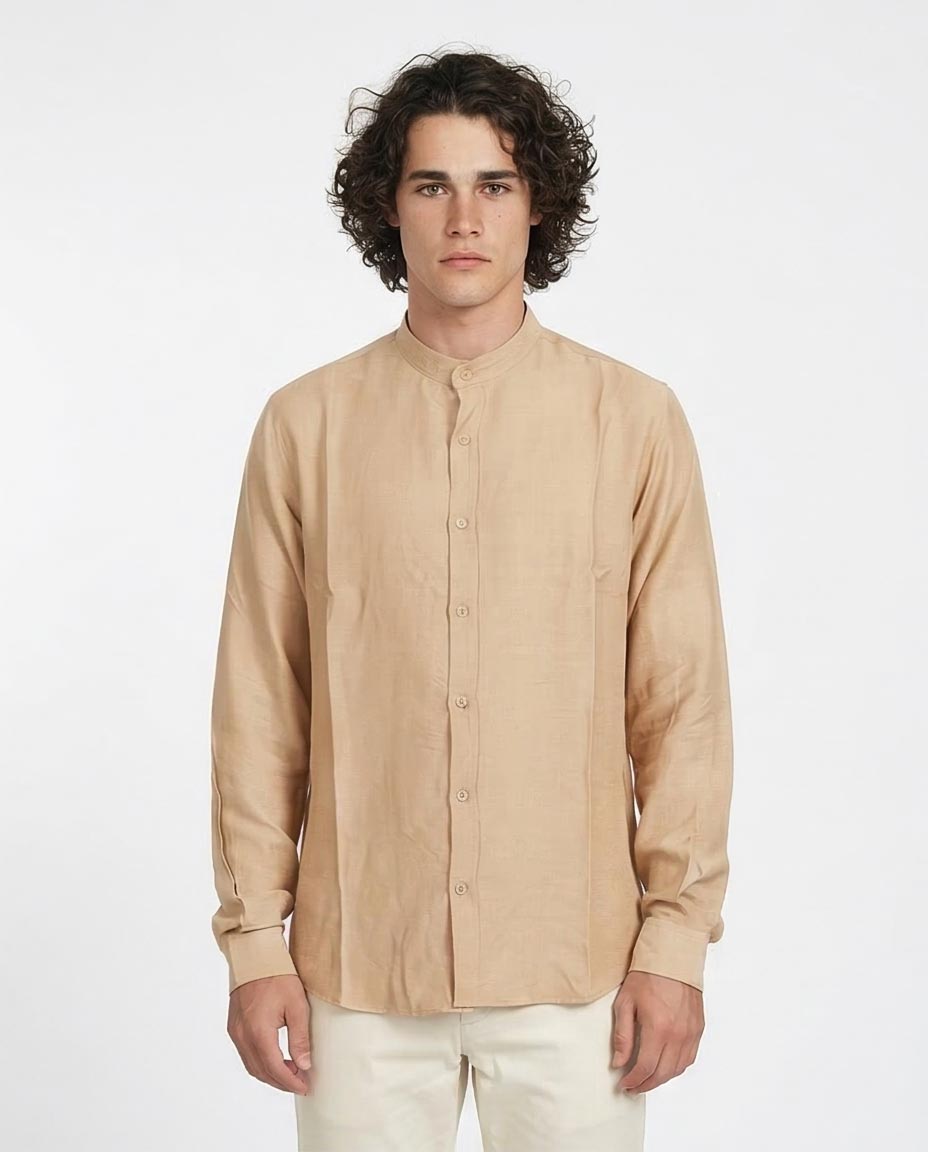 Man wearing a beige button-up shirt against a white background