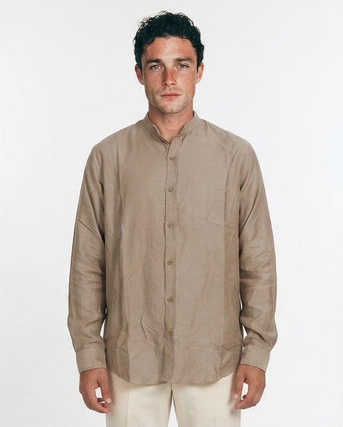 Man wearing a beige long-sleeve shirt on a white background