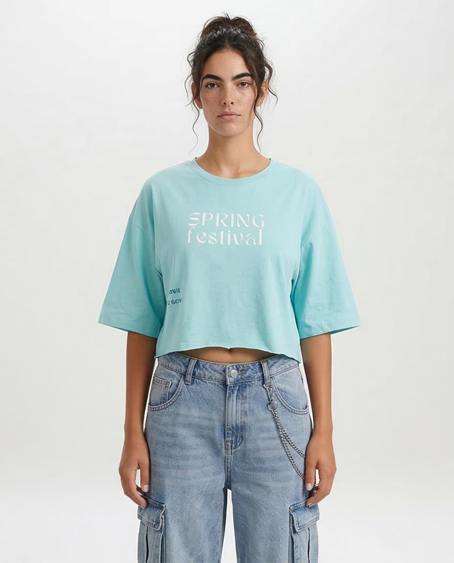 Person wearing a light blue t-shirt with 'Spring Festival' text and blue jeans on a white background
