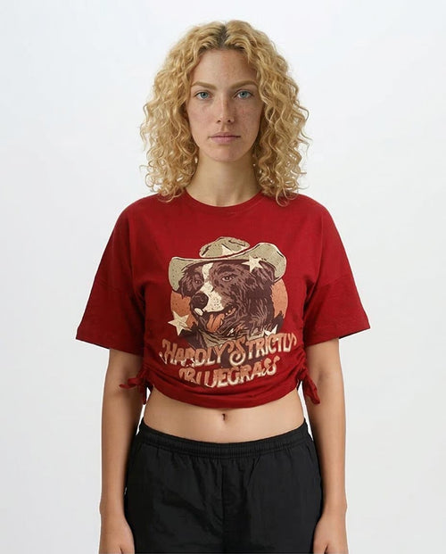 Person wearing a red graphic t-shirt with a bear design and text on a plain background