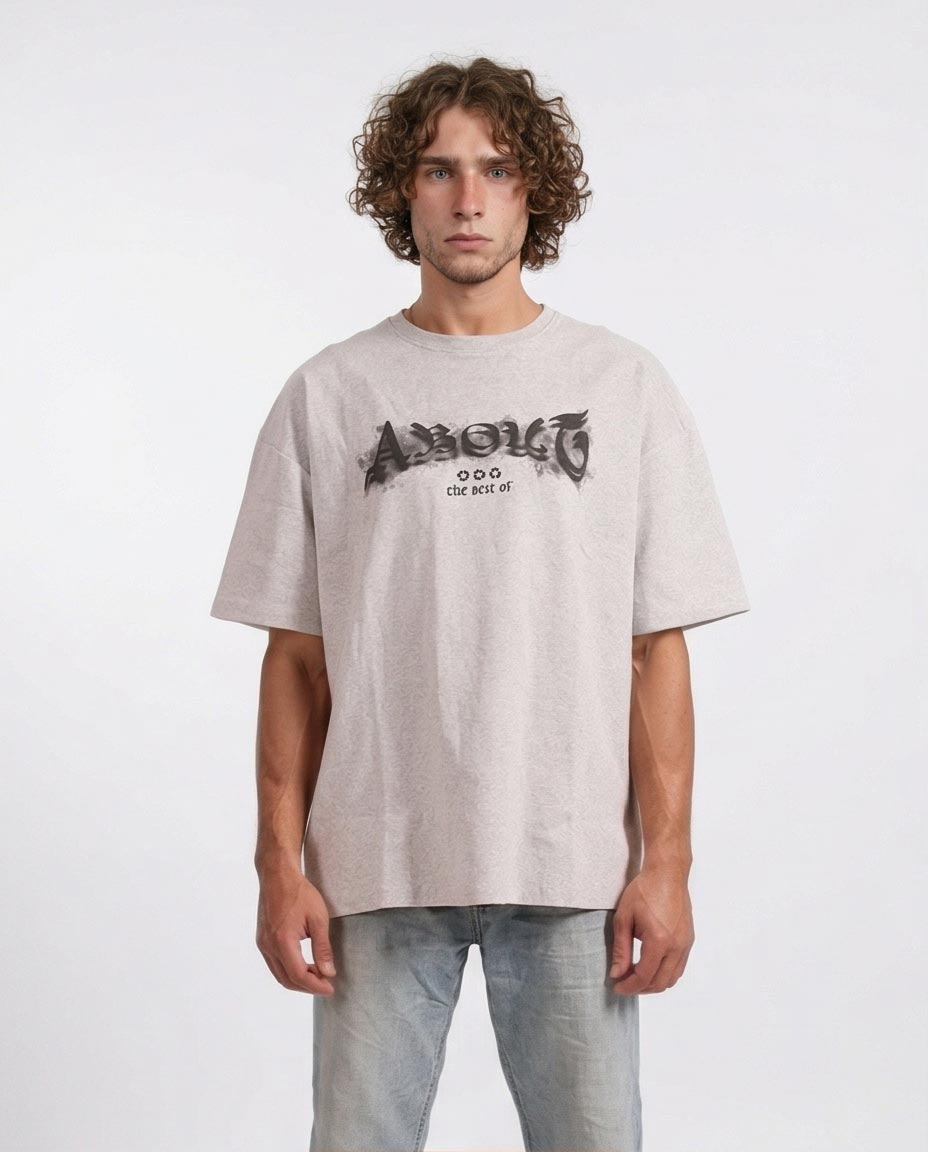 Man wearing a beige t-shirt with a logo on a white background