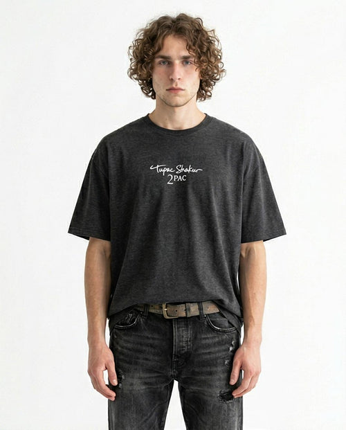 Person wearing a black t-shirt with text on a white background