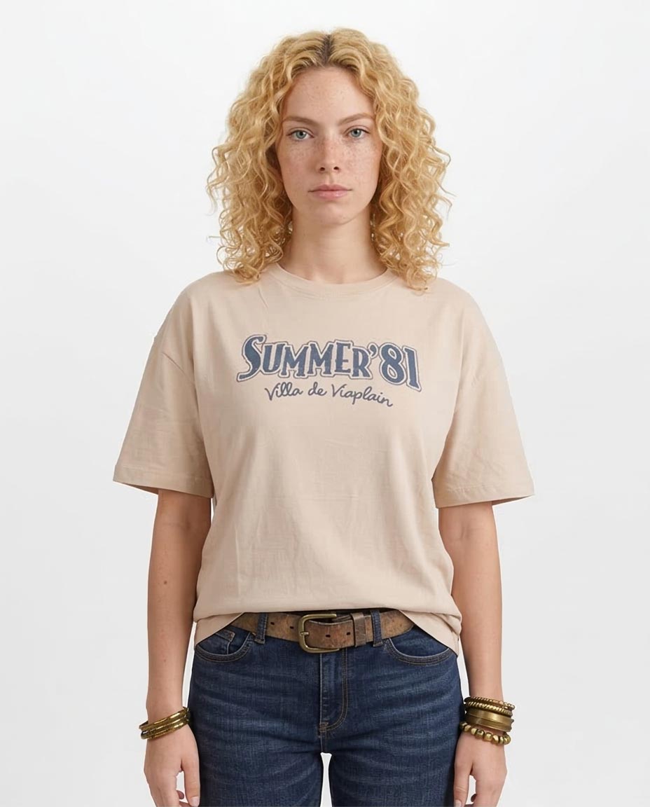 Woman wearing a beige t-shirt with 'Summer '81' text on a white background