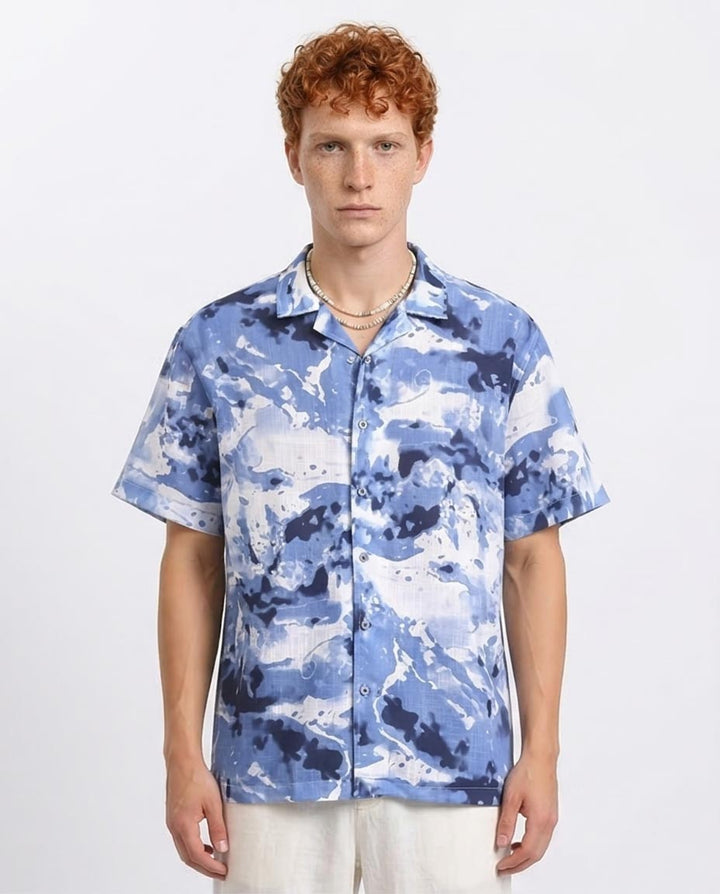 Man wearing a blue camouflage shirt on a white background