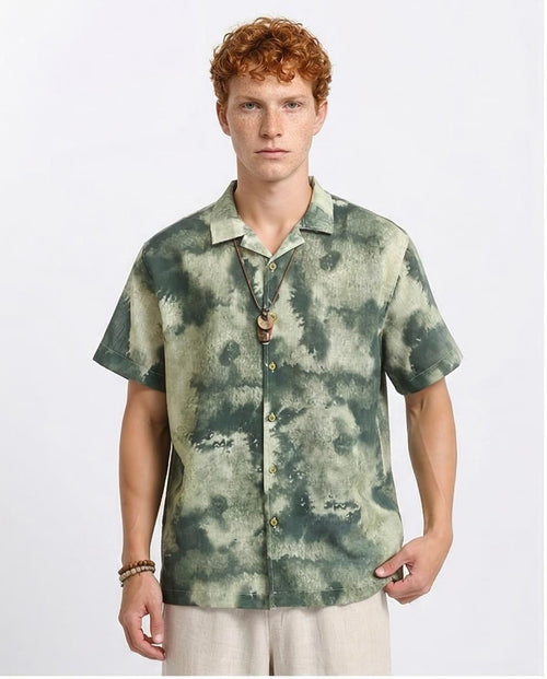 Man wearing a green tie-dye shirt on a white background