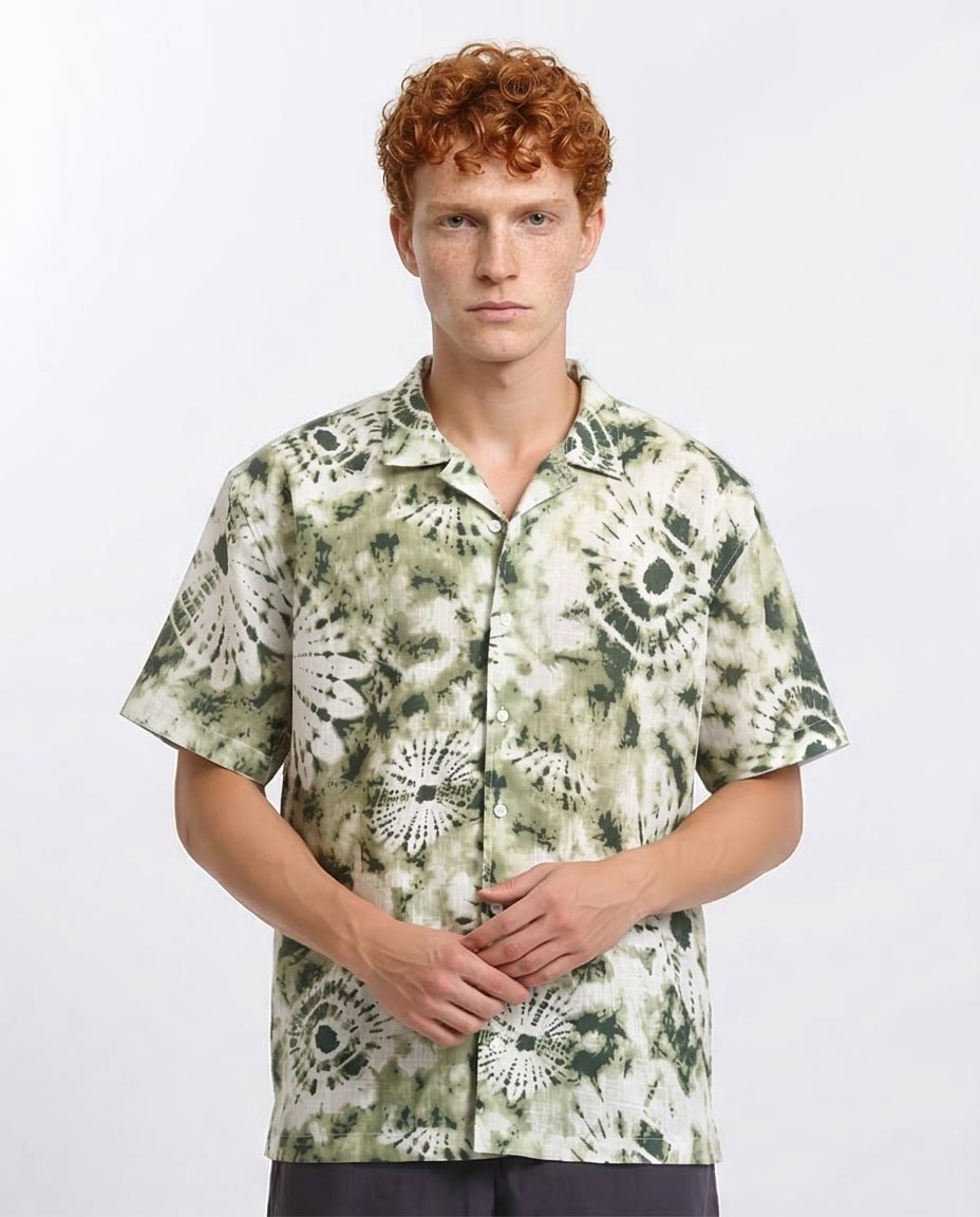 Man wearing a patterned shirt on a white background