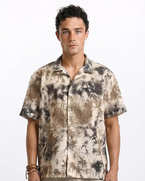 Man wearing a patterned shirt on a white background