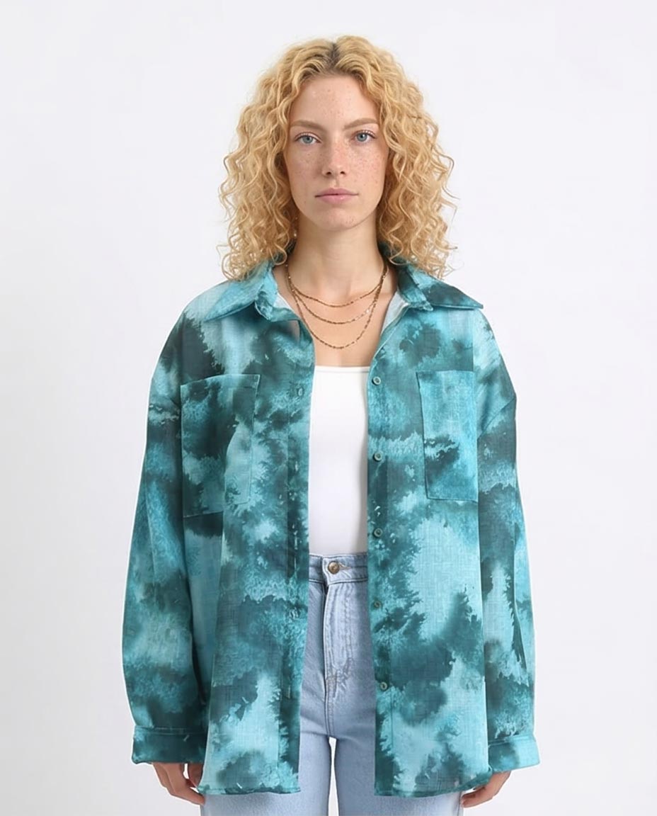 Woman wearing a teal tie-dye jacket on a white background