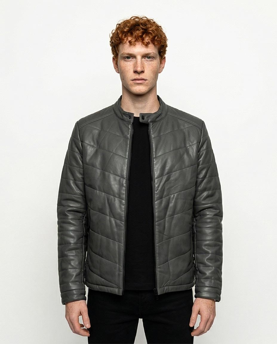 Man wearing a gray quilted jacket on a white background