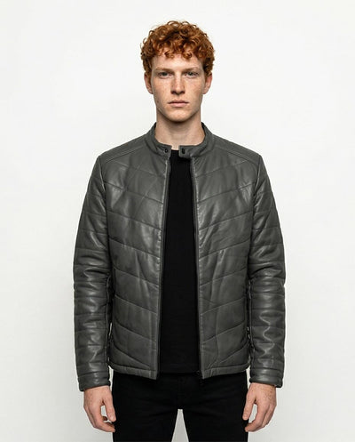 Man wearing a gray quilted jacket on a white background