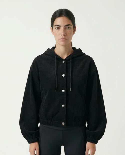 Woman wearing a black jacket with buttons on a white background