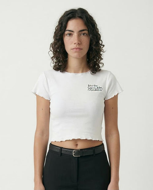 Person wearing a white t-shirt with text on a plain background