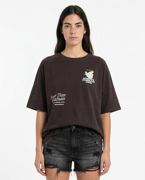 Person wearing a dark brown t-shirt with text and graphics on a white background