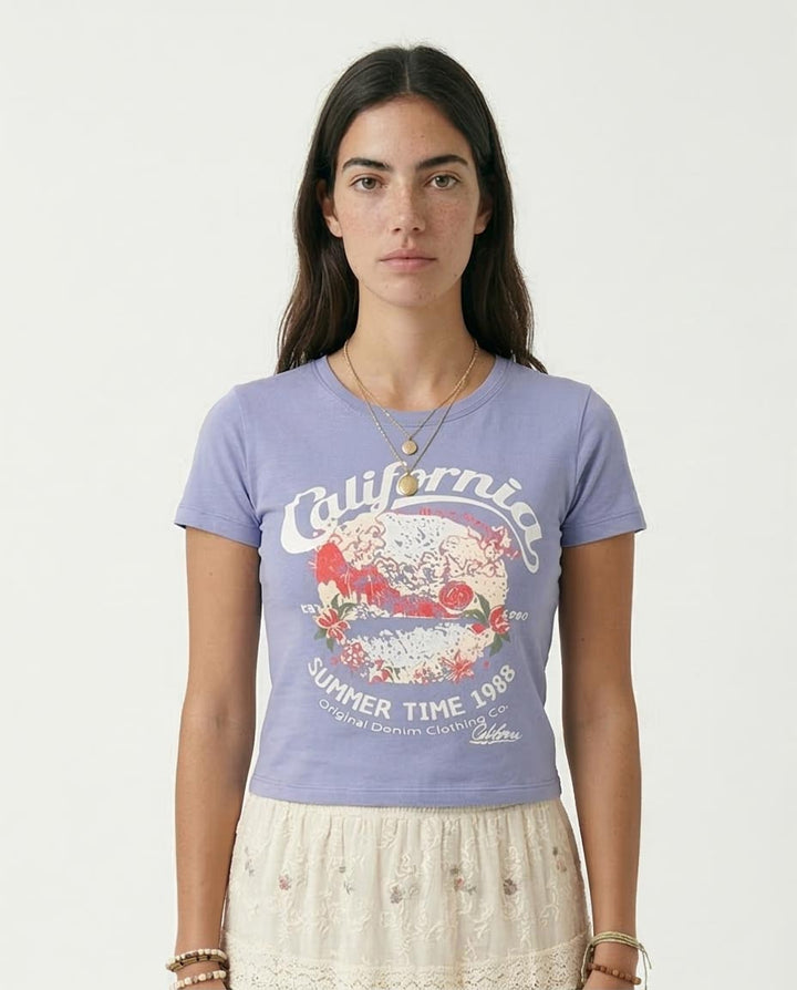 Woman wearing a purple t-shirt with 'California Summer Time 1988' design on a plain background