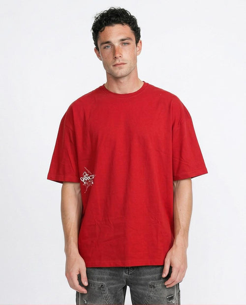 Man wearing a red t-shirt with a logo on a white background