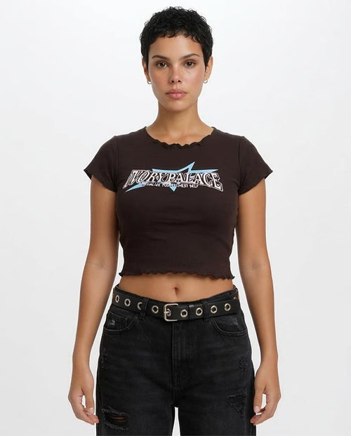 Person wearing a black t-shirt with a logo and black pants on a white background