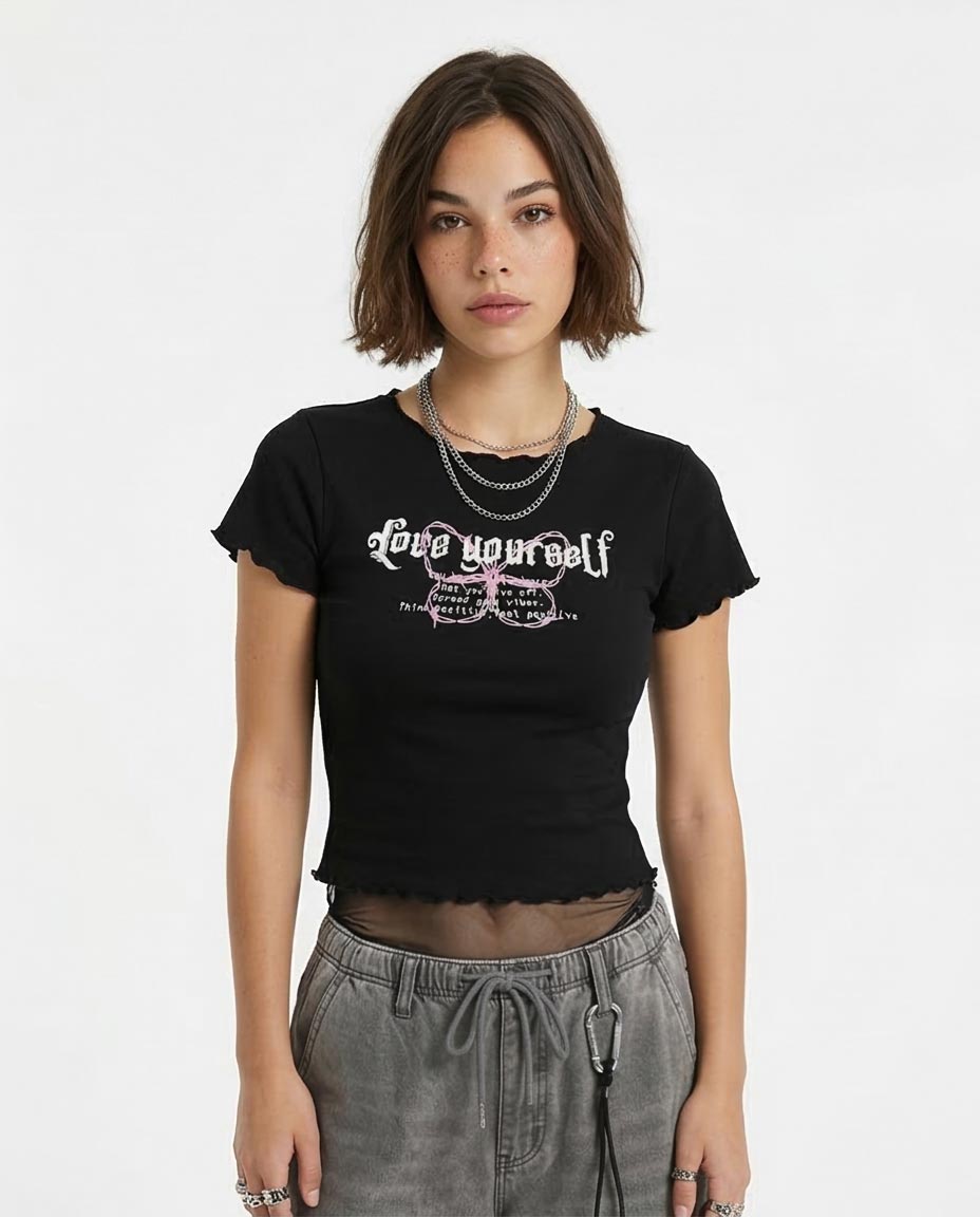 Person wearing a black t-shirt with text on a white background