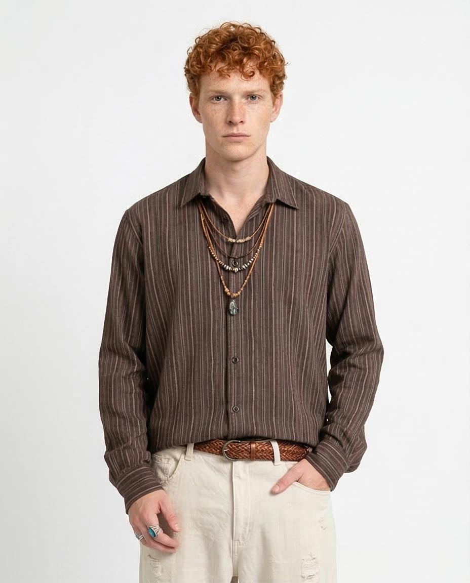 Man wearing a brown striped shirt and beige pants on a white background