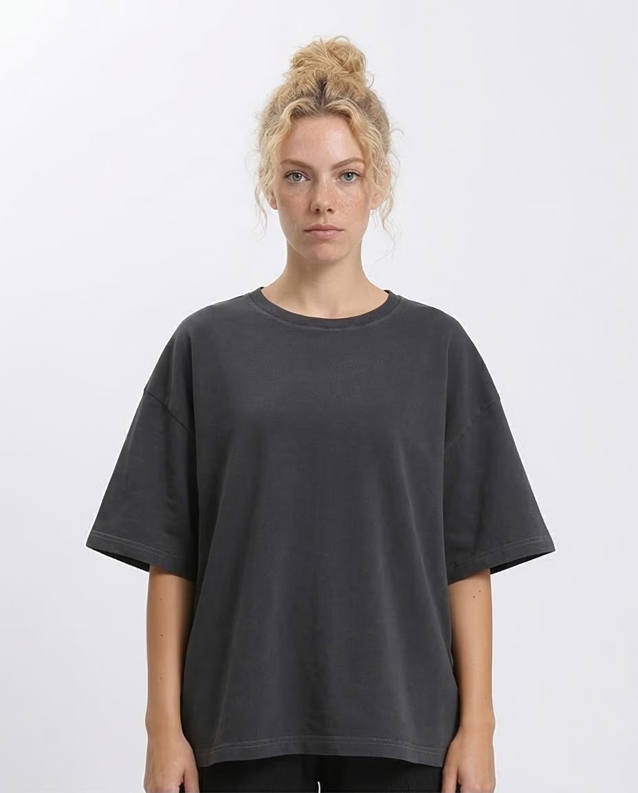 Woman wearing a black oversized t-shirt against a white background