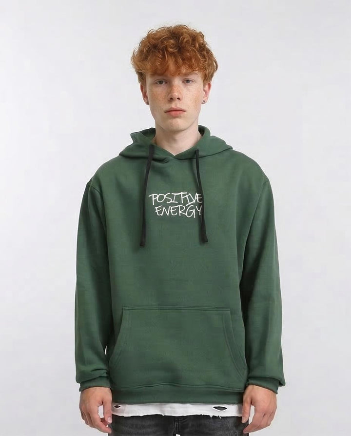 Person wearing a green hoodie with 'Positive Energy' text on a white background
