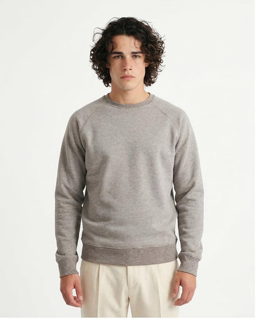 Man wearing a gray sweatshirt against a plain background