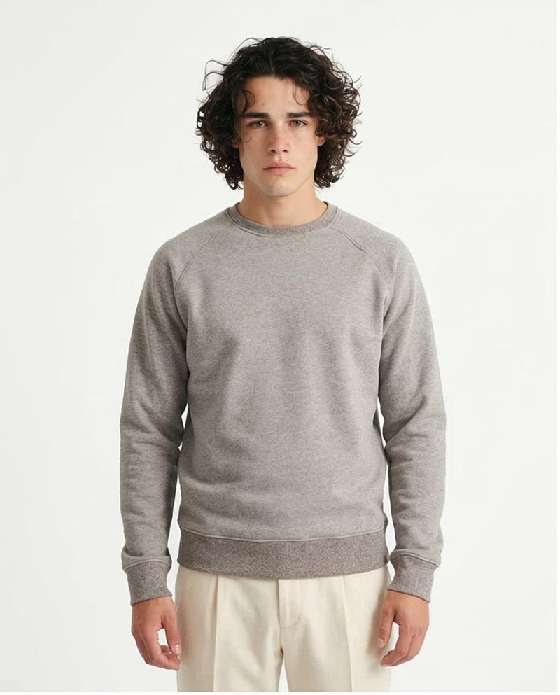 Man wearing a gray sweatshirt against a plain background