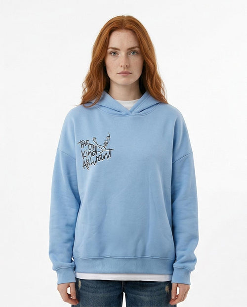 Person wearing a light blue hoodie with text and graphics on a white background