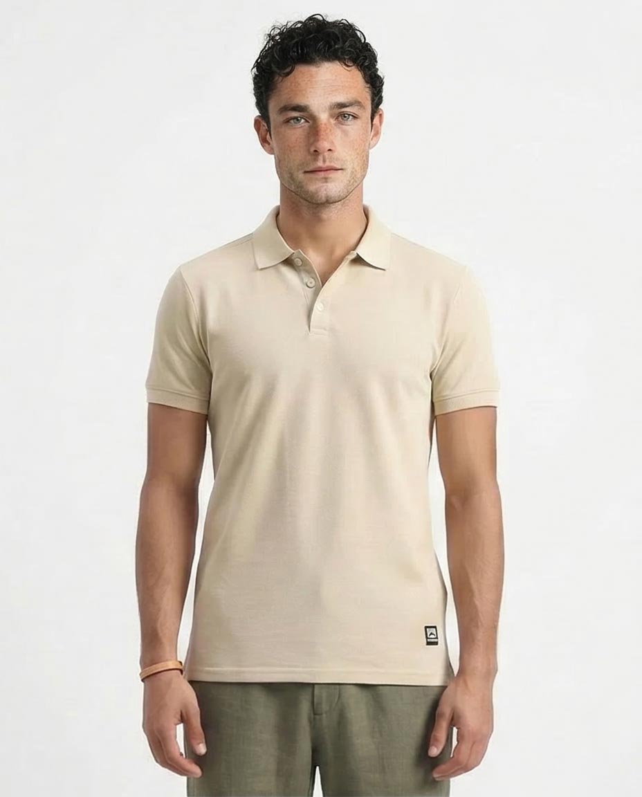Man wearing a beige polo shirt against a white background