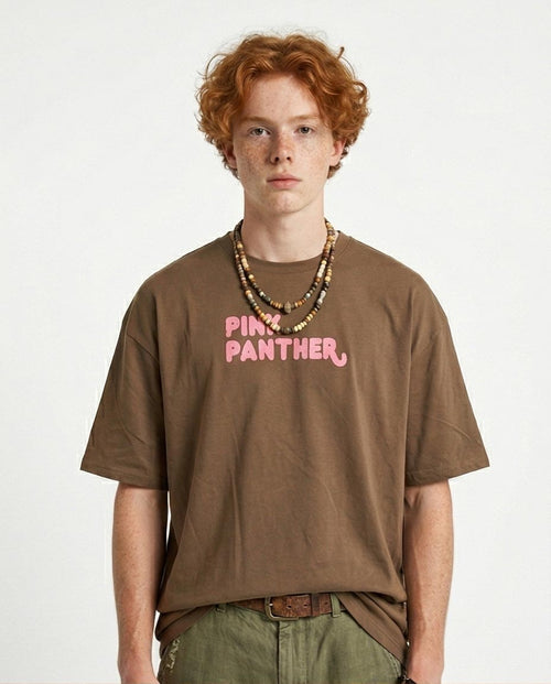 Person wearing a brown t-shirt with 'Pink Panther' text on a white background