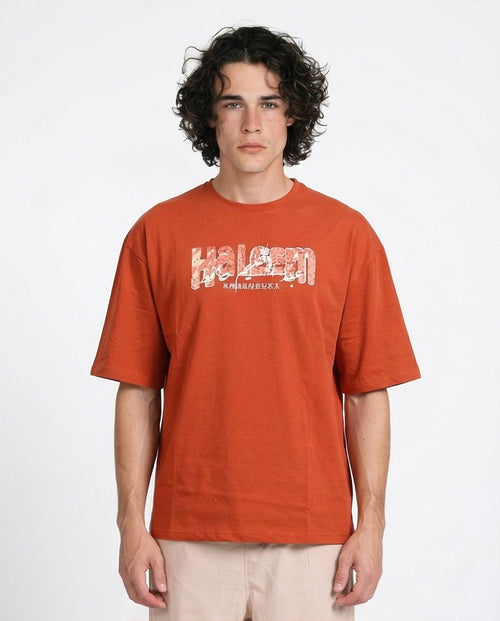 Man wearing an orange t-shirt with a logo on a white background