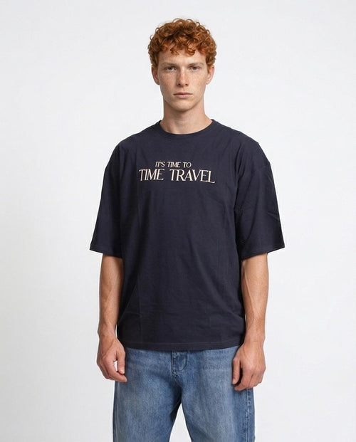 Person wearing a black t-shirt with 'It's time to time travel' text on a white background