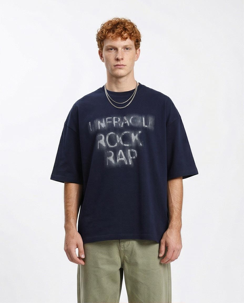 Man wearing a navy blue t-shirt with text on a white background