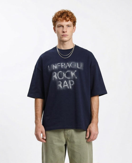 Man wearing a navy blue t-shirt with text on a white background