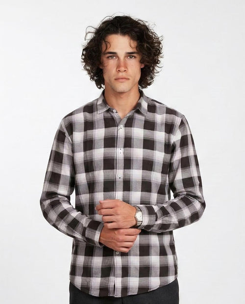 Man wearing a black and white checkered shirt on a white background